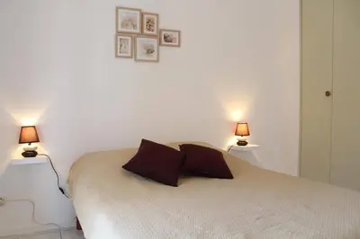 a bedroom with a bed with two lamps on it at Maison 3 pièces mezzanine PORT LA NOUVELLE PN360-013 in Port-la-Nouvelle