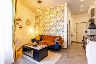 a living room with a couch and a table at Cocon Bohème Proche Gare in Narbonne
