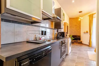 a kitchen with a sink and a stove at Cocon Bohème Proche Gare in Narbonne