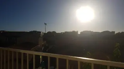 a view of a city with the sun in the sky at Les Vergers in Narbonne