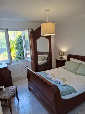 a bedroom with a bed with two dolls on it at Chez Maxou - 3 ēpis Jardin Clos-Garage-Dogfriendly in Revel