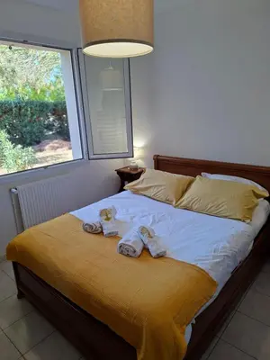 a bedroom with a bed with towels on it at Chez Maxou - 3 ēpis Jardin Clos-Garage-Dogfriendly in Revel
