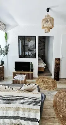 a living room with two beds and a fireplace at N1-Terrasse - Barbacane - Pieds Cité - Clime Mobile in Carcassonne
