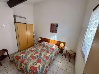 a bedroom with a bed with a colorful comforter at Maison deux pièces cabine PORT LA NOUVELLE PN370-026 in Port-la-Nouvelle