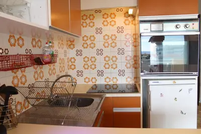 a kitchen with a sink and a dish drying rack at Appartement 2 pièces PORT LA NOUVELLE PN440-024 in Port-la-Nouvelle