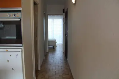 a hallway leading to a kitchen with a hallway leading to a bedroom at Appartement 2 pièces PORT LA NOUVELLE PN440-024 in Port-la-Nouvelle