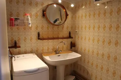 a bathroom with a sink and a mirror and a toilet at Appartement 2 pièces PORT LA NOUVELLE PN440-024 in Port-la-Nouvelle
