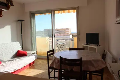 a living room with a table and a couch at Appartement 2 pièces PORT LA NOUVELLE PN440-024 in Port-la-Nouvelle