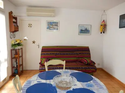 a living room with a table and a couch at Maison 3 pièces PORT LA NOUVELLE PN500-005 in Port-la-Nouvelle