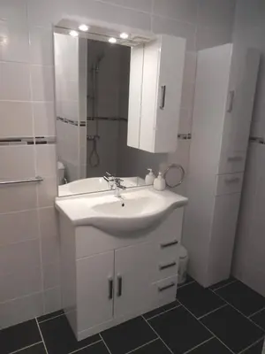 a white bathroom with a sink and a shower at Maison 3 pièces PORT LA NOUVELLE PN500-005 in Port-la-Nouvelle