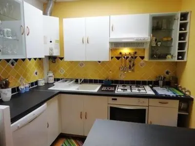 a kitchen with white cabinets and a counter top at Maison 3 pièces PORT LA NOUVELLE PN500-005 in Port-la-Nouvelle