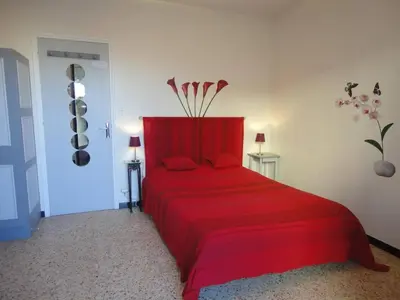 a bedroom with a red bed with red sheets at Appartement 2 pièces PORT LA NOUVELLE PN520-031 in Port-la-Nouvelle