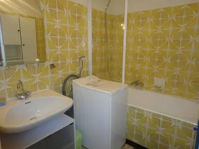a bathroom with a sink and a toilet and a mirror at Appartement 2 pièces PORT LA NOUVELLE PN520-031 in Port-la-Nouvelle
