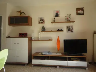 a living room with a flat screen tv on the wall at Appartement 2 pièces PORT LA NOUVELLE PN520-031 in Port-la-Nouvelle