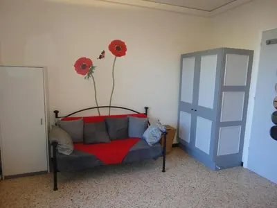 a room with a bed with a flower on the wall at Appartement 2 pièces PORT LA NOUVELLE PN520-031 in Port-la-Nouvelle