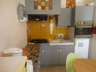 a small kitchen with a sink and a stove at Appartement 2 pièces PORT LA NOUVELLE PN520-031 in Port-la-Nouvelle