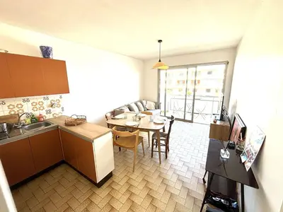 a kitchen and dining room with a table and a dining room at Appartement 3 pièces Port-la-Nouvelle PN550-012 in Port-la-Nouvelle