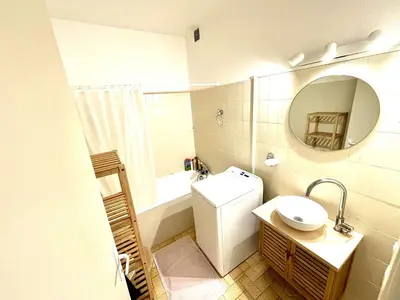 a bathroom with a toilet and a sink and a mirror at Appartement 3 pièces Port-la-Nouvelle PN550-012 in Port-la-Nouvelle