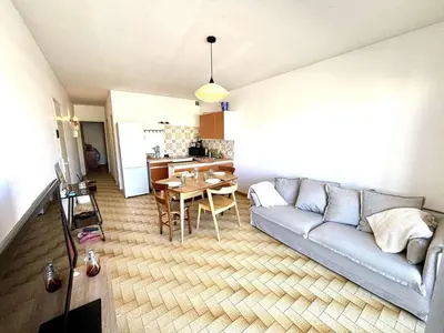 a living room with a couch and a table at Appartement 3 pièces Port-la-Nouvelle PN550-012 in Port-la-Nouvelle
