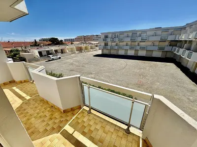 a balcony of a building with a parking lot at Appartement 3 pièces Port-la-Nouvelle PN550-012 in Port-la-Nouvelle
