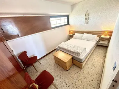 a small room with a bed and a chair at Appartement 2 pièces - Port La Nouvelle PN590-025 in Port-la-Nouvelle