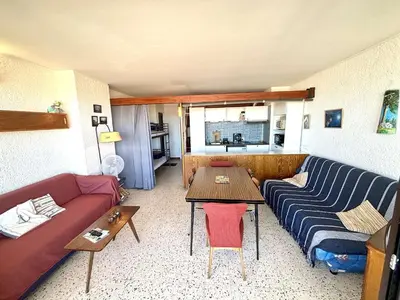 a living room with a couch and a table at Appartement 2 pièces - Port La Nouvelle PN590-025 in Port-la-Nouvelle