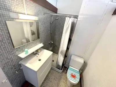 a bathroom with a sink and a toilet and a mirror at Appartement 2 pièces - Port La Nouvelle PN590-025 in Port-la-Nouvelle