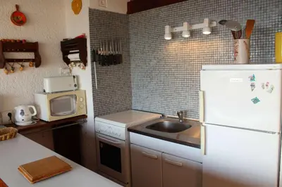 a kitchen with a sink and a white refrigerator at Appartement 2 pièces PORT LA NOUVELLE PN590-033 in Port-la-Nouvelle