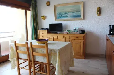 a dining room with a table and a television at Appartement 2 pièces PORT LA NOUVELLE PN590-033 in Port-la-Nouvelle