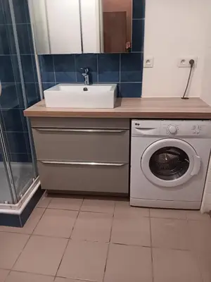a bathroom with a sink and a washing machine at Studio in Lézignan-Corbières