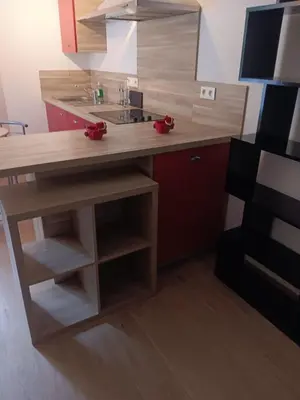 a kitchen with a wooden counter with red bows on it at Studio in Lézignan-Corbières
