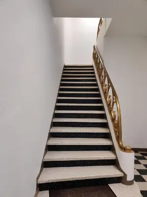 a staircase with a gold railing and a stair case at Studio in Lézignan-Corbières