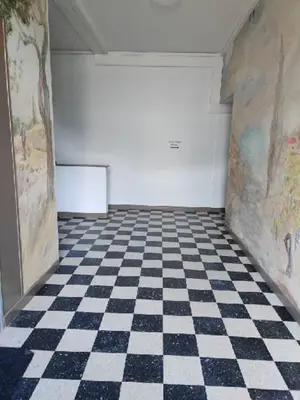 a room with a checkered floor and a white wall at Studio in Lézignan-Corbières