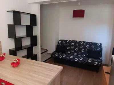 a living room with a couch and a table at Studio in Lézignan-Corbières