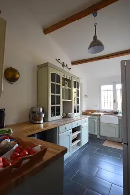 a kitchen with white cabinets and a counter top at l escapade Corbières in Lagrasse