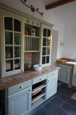a kitchen with white cabinets and a counter at l escapade Corbières in Lagrasse