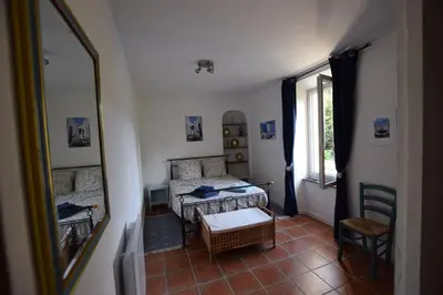 a small bedroom with a bed and a mirror at l escapade Corbières in Lagrasse