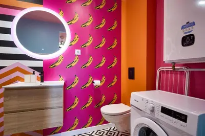a bathroom with a bunch of bananas on a pink wall at La Villa Orange - POP'ART - proche cité médiévale et centre ville à pied in Carcassonne