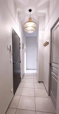 a hallway with a door and a light fixture at Le Nayrac l Hypercentre l Parking privé in Castres