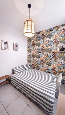 a bedroom with a bed with a colorful wall at Le Nayrac l Hypercentre l Parking privé in Castres