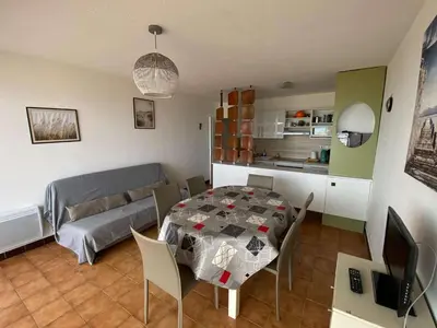a living room with a table and a couch at Appartement 3 pièces PORT LA NOUVELLE PN210-064 in Port-la-Nouvelle