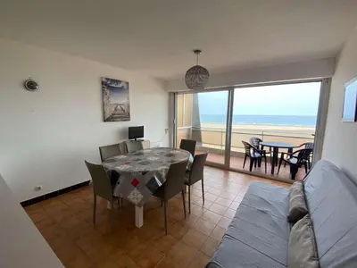 a dining room with a table and a view of the ocean at Appartement 3 pièces PORT LA NOUVELLE PN210-064 in Port-la-Nouvelle