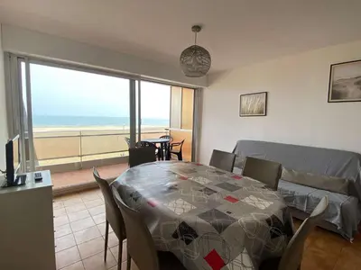 a dining room with a table and a view of the ocean at Appartement 3 pièces PORT LA NOUVELLE PN210-064 in Port-la-Nouvelle