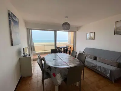 a living room with a table and a couch at Appartement 3 pièces PORT LA NOUVELLE PN210-064 in Port-la-Nouvelle
