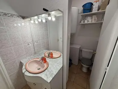 a small bathroom with a toilet and a sink at Appartement 2 pièces PORT LA NOUVELLE PN430-027 in Port-la-Nouvelle