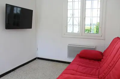 a living room with a red couch and a window at Maison 3 pièces PORT LA NOUVELLE PN000-156 in Port-la-Nouvelle