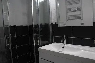 a bathroom with a sink and a shower with a mirror at Maison 3 pièces PORT LA NOUVELLE PN000-156 in Port-la-Nouvelle