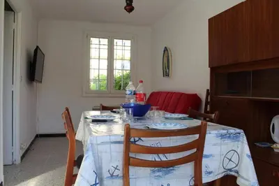 a dining room table with a table cloth on it at Maison 3 pièces PORT LA NOUVELLE PN000-156 in Port-la-Nouvelle