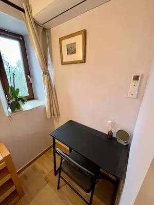 a small black table in a room with a window at La bergerie - Paisible vue lac et montagne in Molleville
