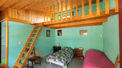 a bedroom with a bunk bed and a ladder at L'Orchidée chambres d'hôtes in Hounoux